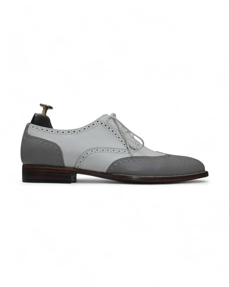 Close-up of Gray & White Wing Tip Leather Oxfords