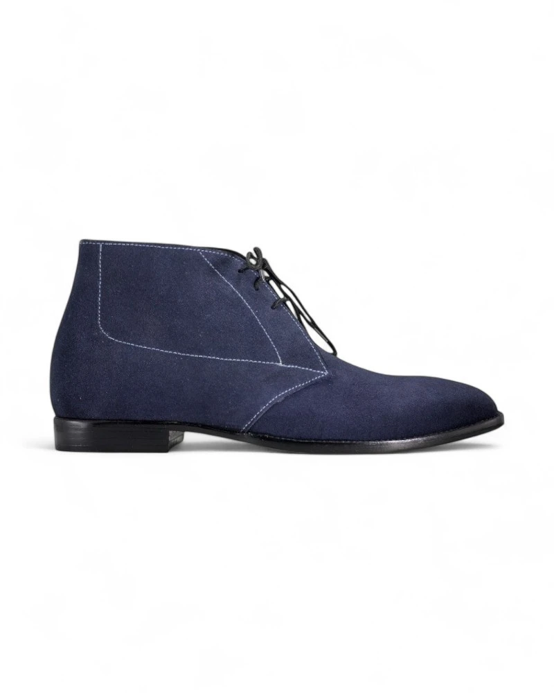 Navy blue suede chukka boots for men with a classic lace-up design.